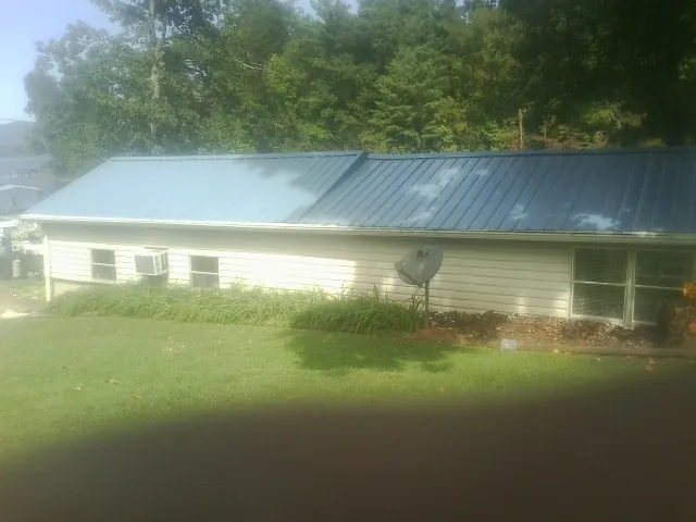Blue metal roof running the length of a single story home in Little Suamico